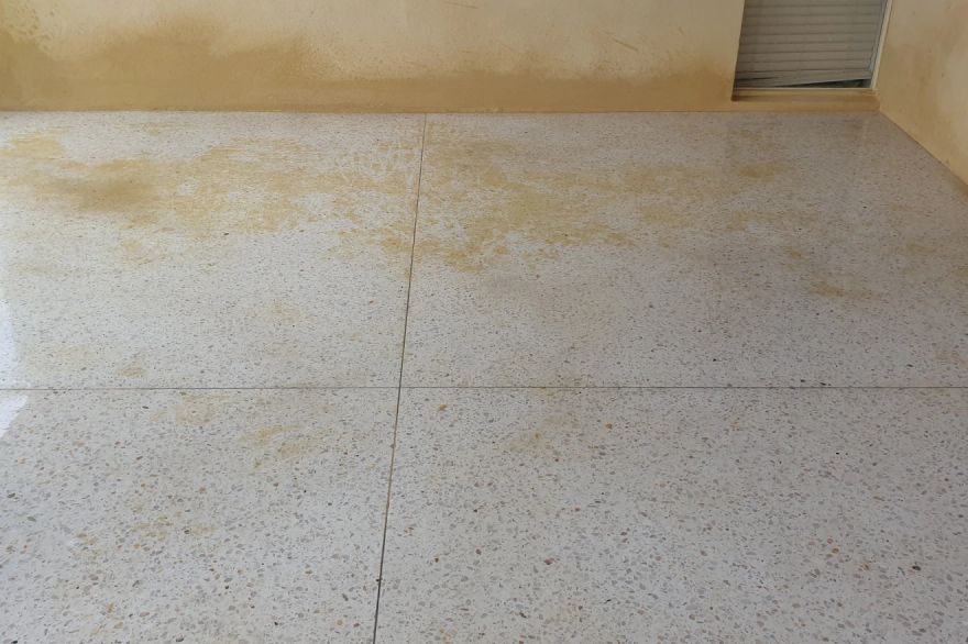 Before and after cleaning on concrete exposed aggregate · Garage floor: before