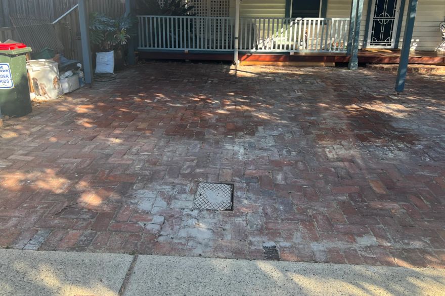 Before and after cleaning on brick pavers: before
