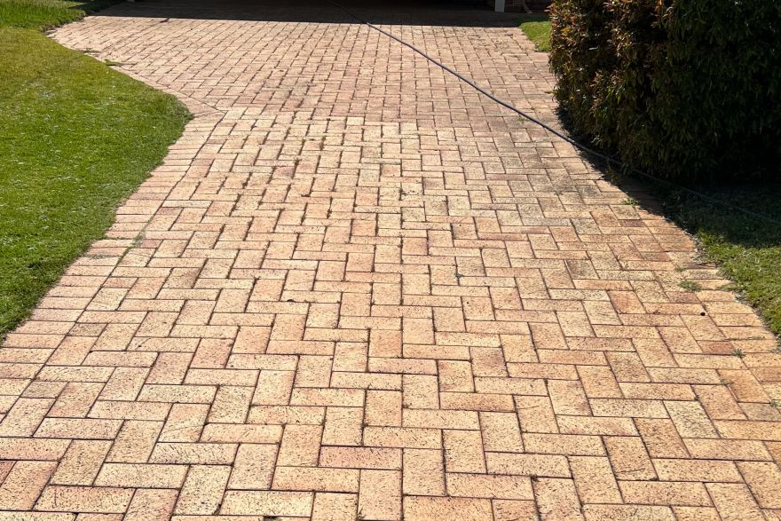 Before and after cleaning on brick pavers · Driveway: before