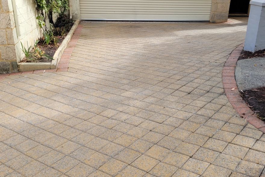 Before and after cleaning on brick pavers · Driveway: after