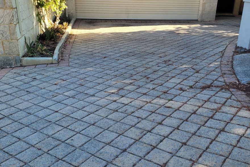 Before and after cleaning on brick pavers · Driveway: before