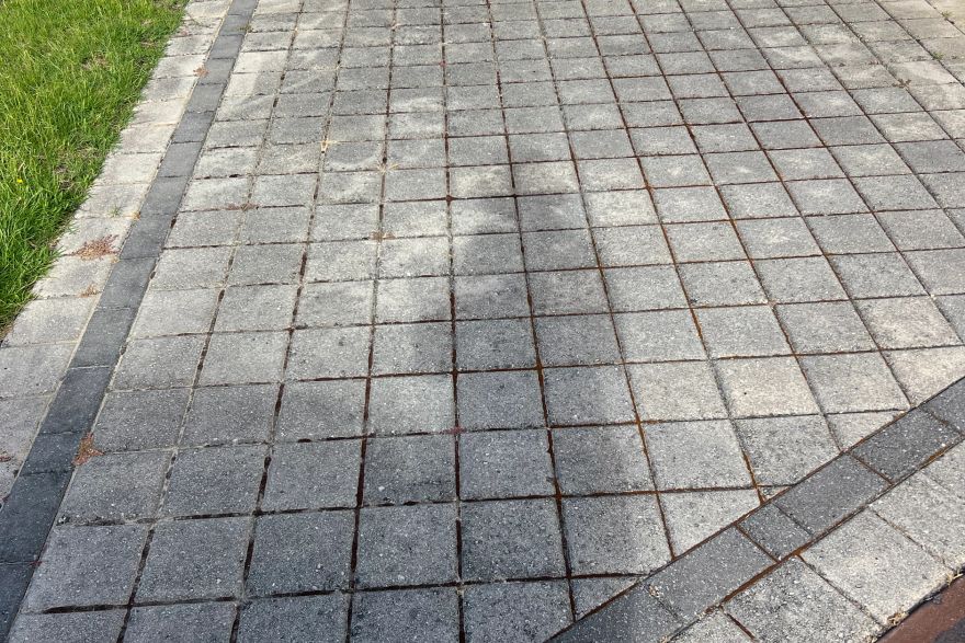 Before and after cleaning on brick pavers: before