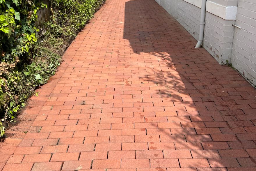 Before and after cleaning on brick pavers · Driveway: after