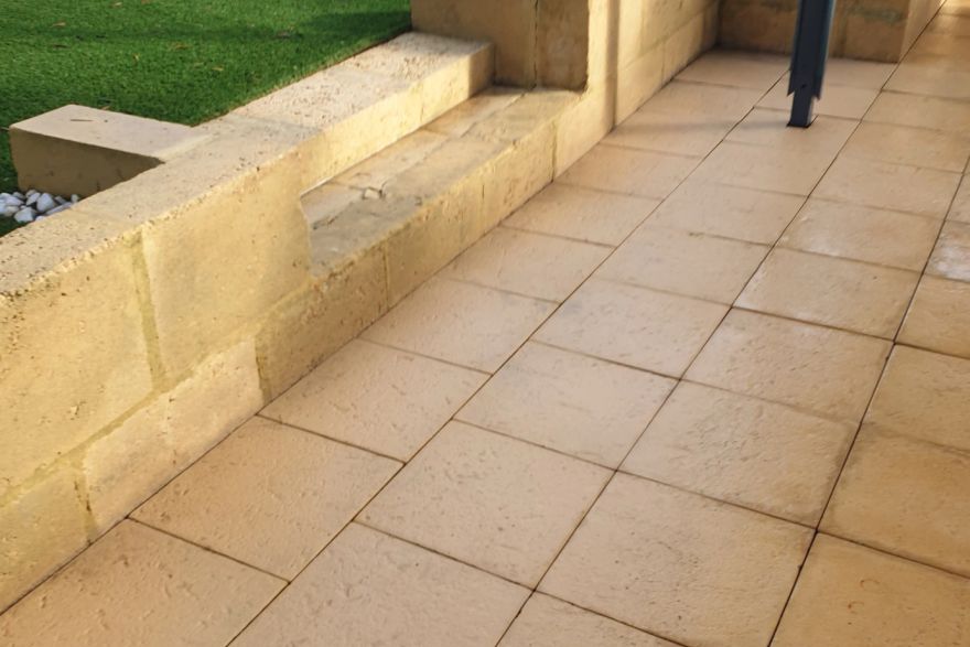 Before and after cleaning on limestone block, sandstone pavers · Patio / alfresco: after