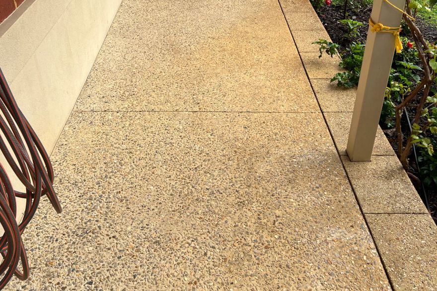 Before and after rust / bore stains on concrete exposed aggregate: before