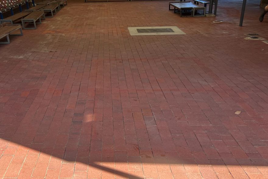 Before and after paint removal on brick pavers: after