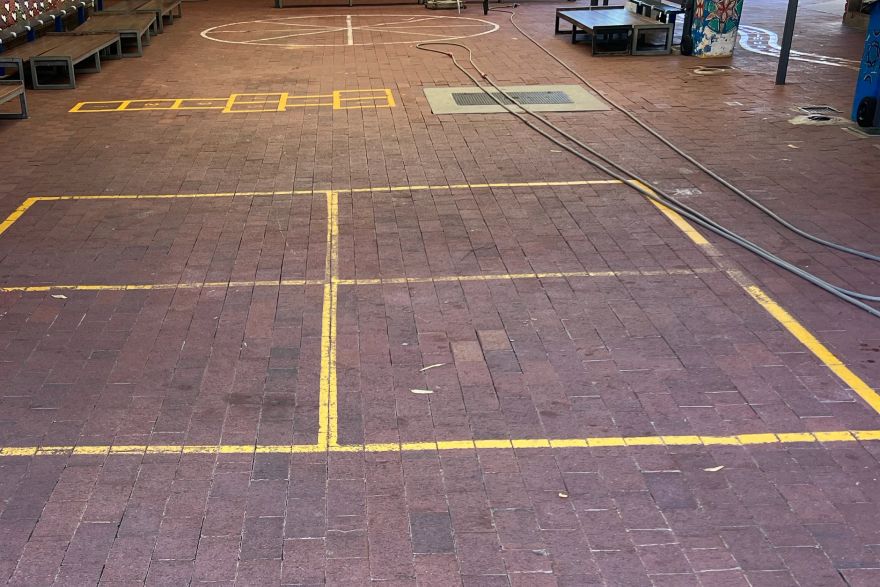 Before and after paint removal on brick pavers: before
