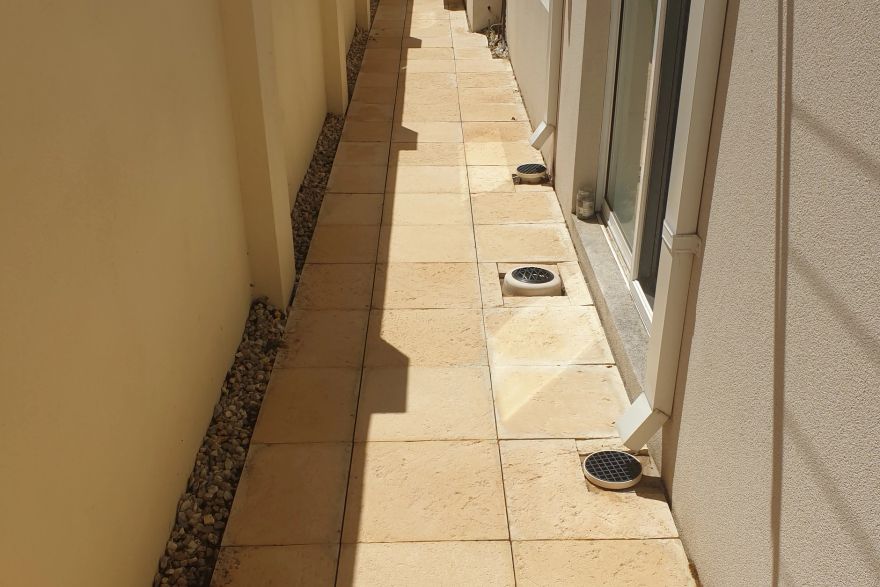 Before and after cleaning on sandstone pavers · Path: after