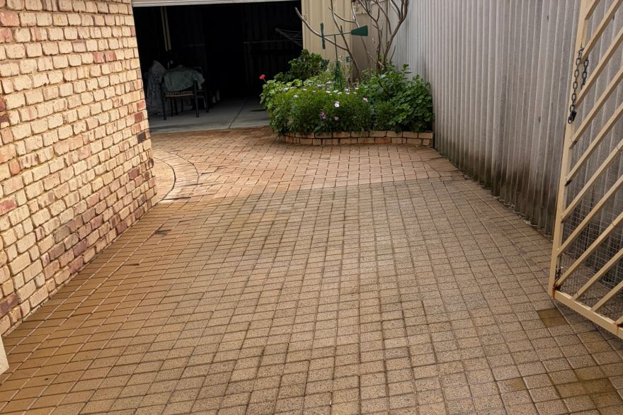 Before and after cleaning on brick pavers · Driveway: after