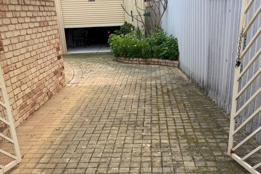 Before and after cleaning on brick pavers · Driveway: before