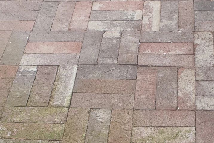 Before and after cleaning on brick pavers: before