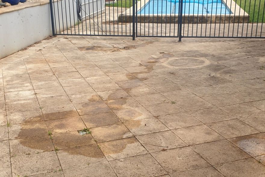 Before and after cleaning on brick pavers: before