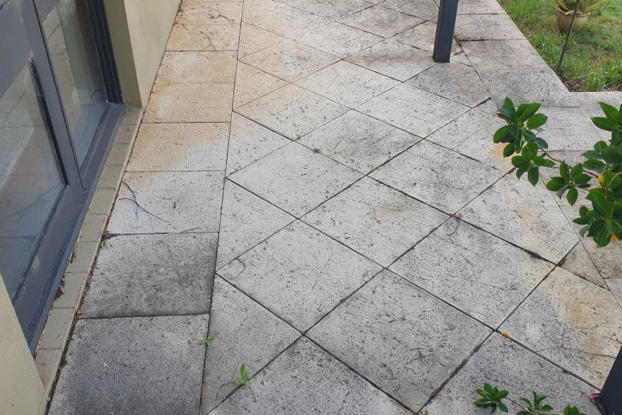 Before and after cleaning on sandstone pavers: before