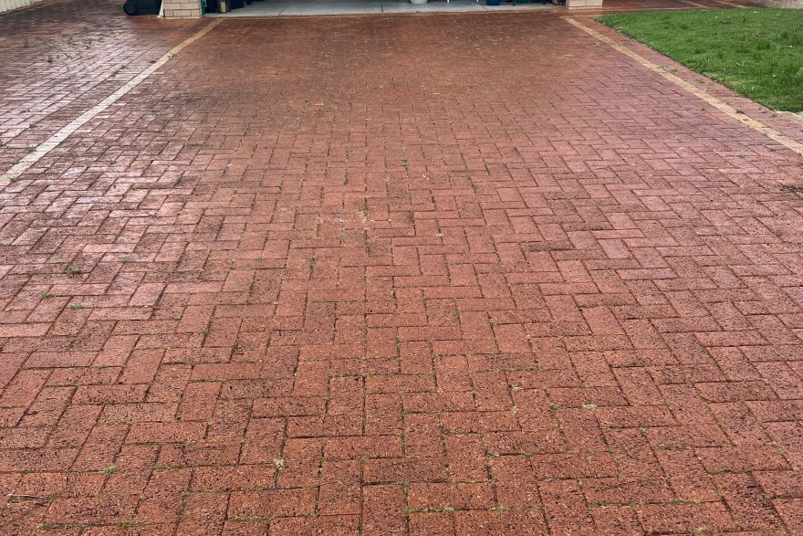 Before and after cleaning on brick pavers · Driveway: before