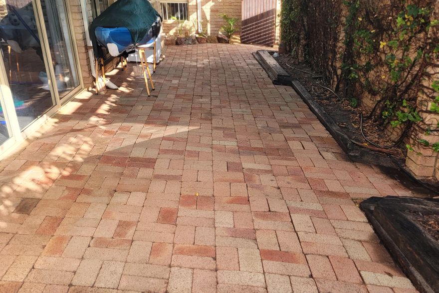 Before and after cleaning on brick pavers · Patio / alfresco: after
