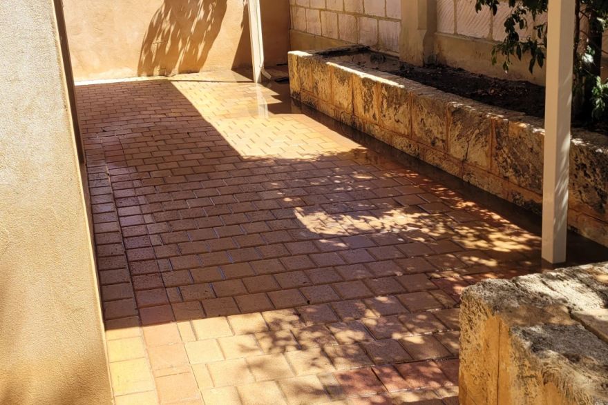 Before and after cleaning on brick pavers · Patio / alfresco: after