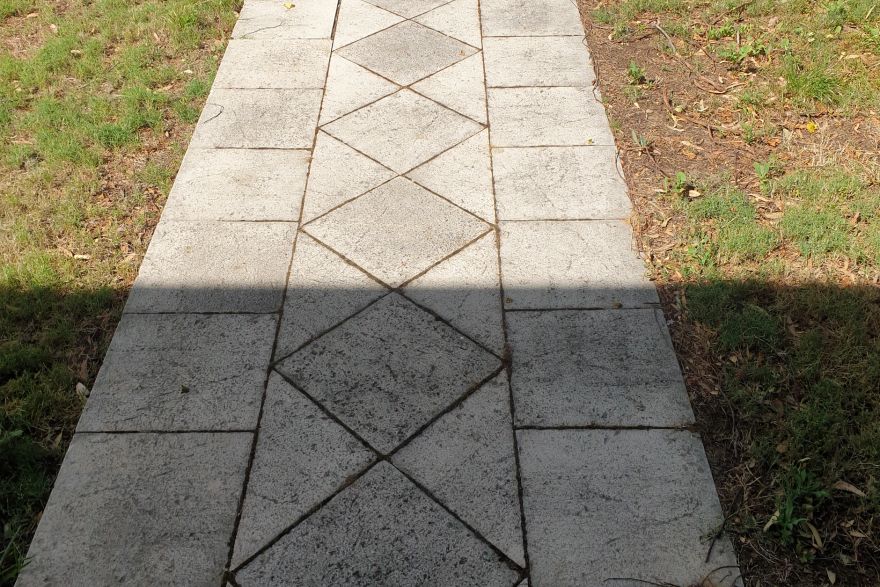 Before and after cleaning on sandstone pavers: before