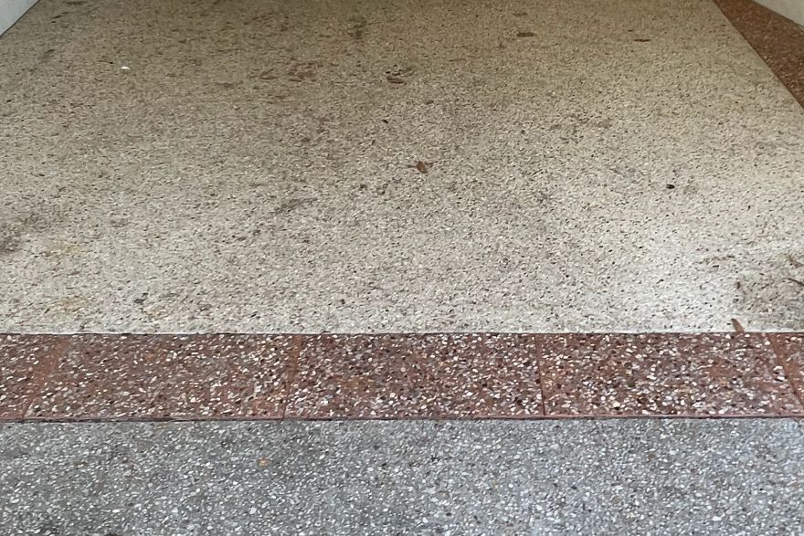 Before and after cleaning on concrete exposed aggregate: before