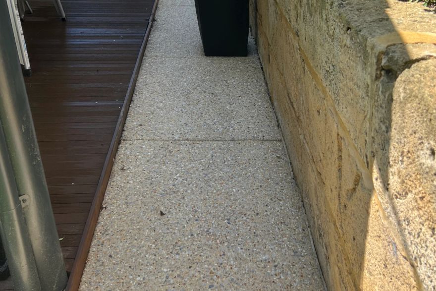Before and after cleaning on concrete exposed aggregate · Path: after