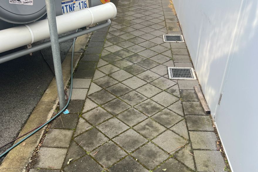 Before and after cleaning on brick pavers: before
