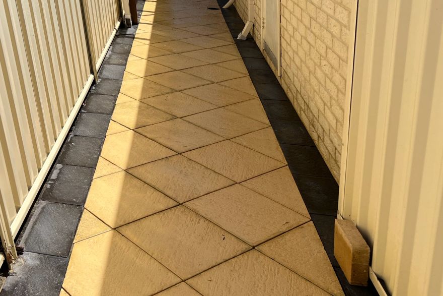 Before and after cleaning on sandstone pavers · Path: after