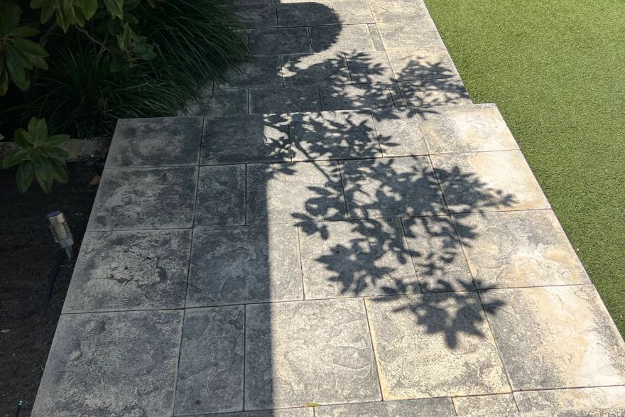 Before and after cleaning on sandstone pavers: before