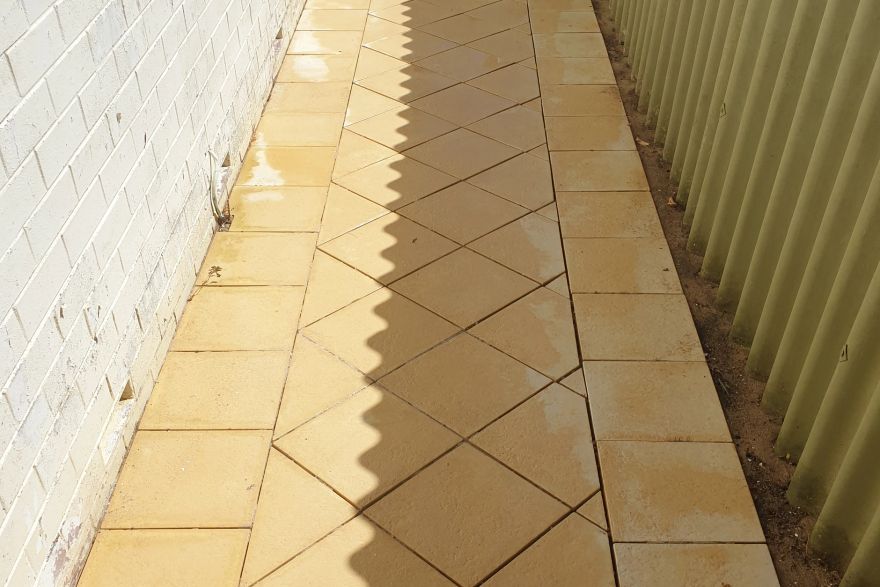 Before and after cleaning on sandstone pavers · Path: after