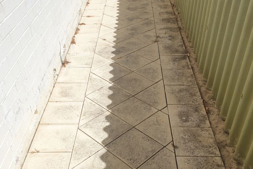 Before and after cleaning on sandstone pavers · Path: before