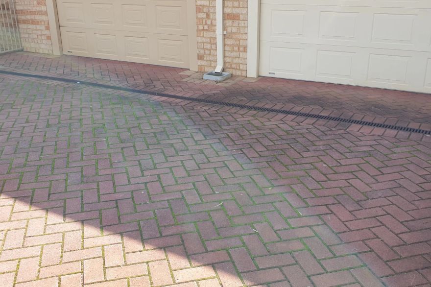 Before and after cleaning on brick pavers · Driveway: before