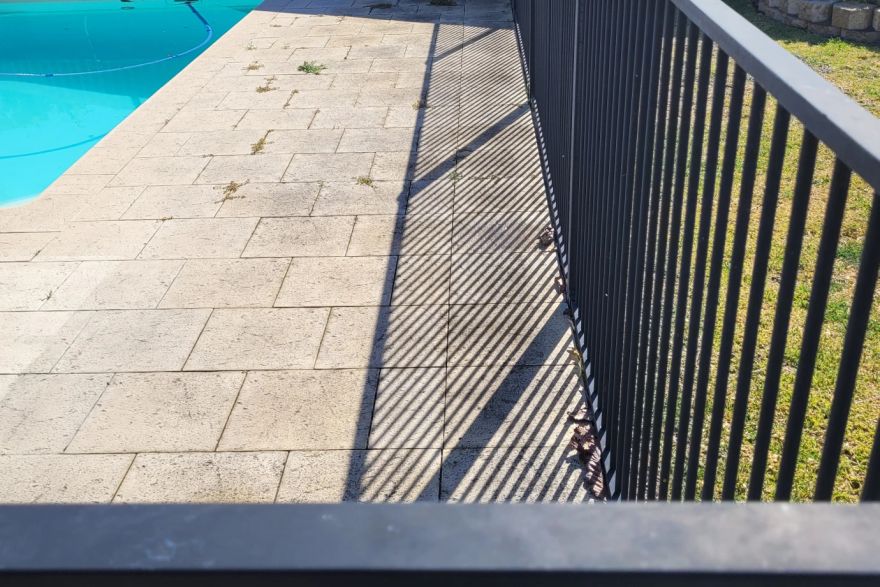 Before and after cleaning on sandstone pavers · Poolside: before