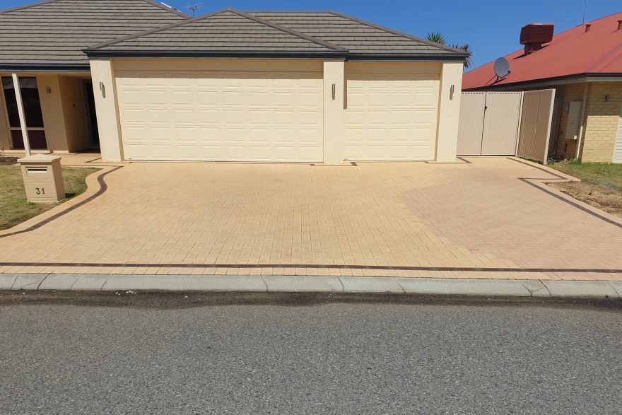 Before and after cleaning on brick pavers · Driveway: after
