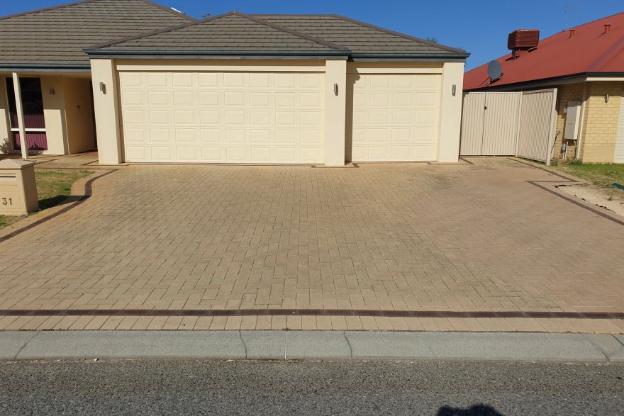Before and after cleaning on brick pavers · Driveway: before