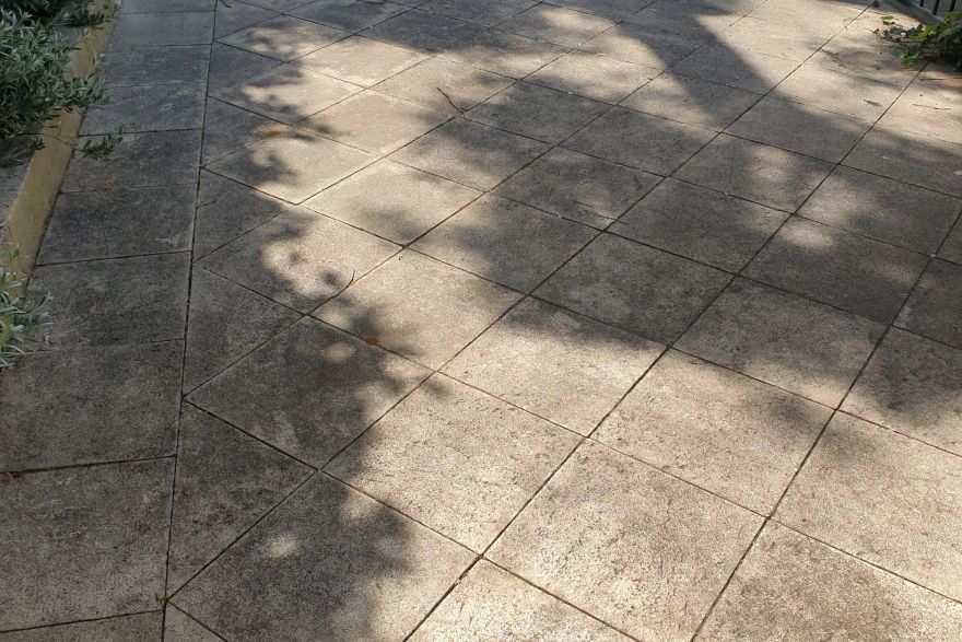 Before and after cleaning on sandstone pavers: before
