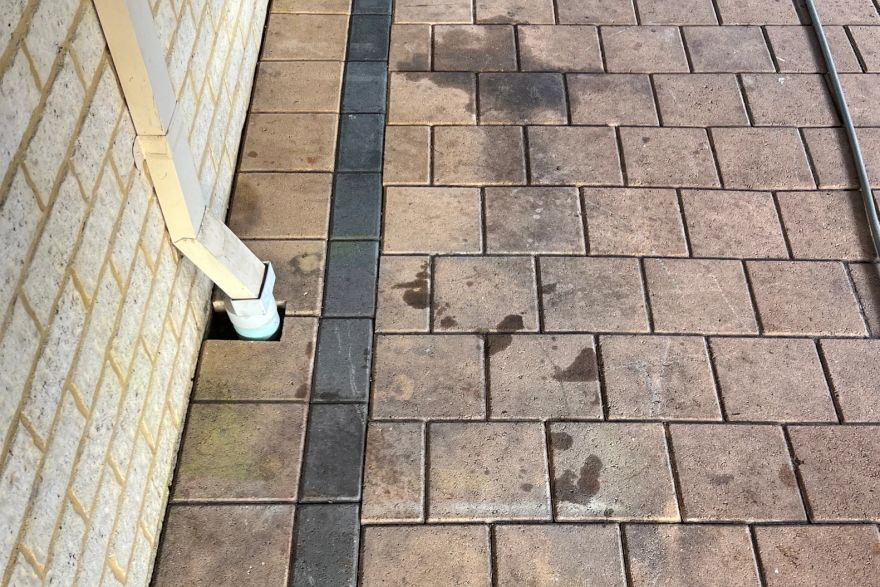Before and after cleaning on brick pavers: before