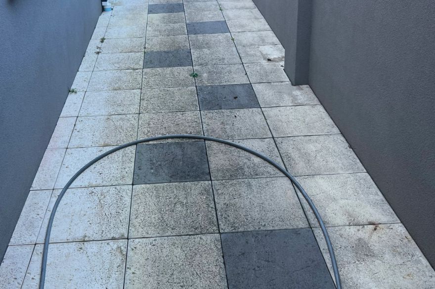 Before and after cleaning on sandstone pavers · Path: before