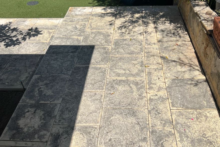 Before and after cleaning on sandstone pavers: before