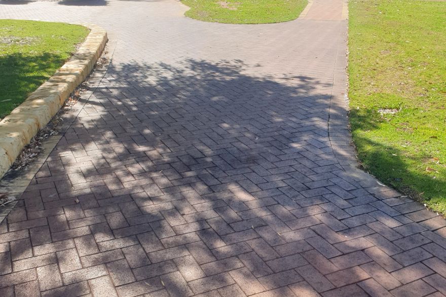 Before and after cleaning on brick pavers: before