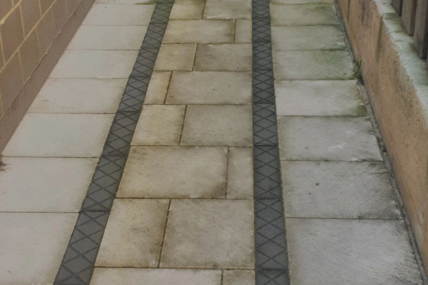 Before and after cleaning on sandstone pavers: before