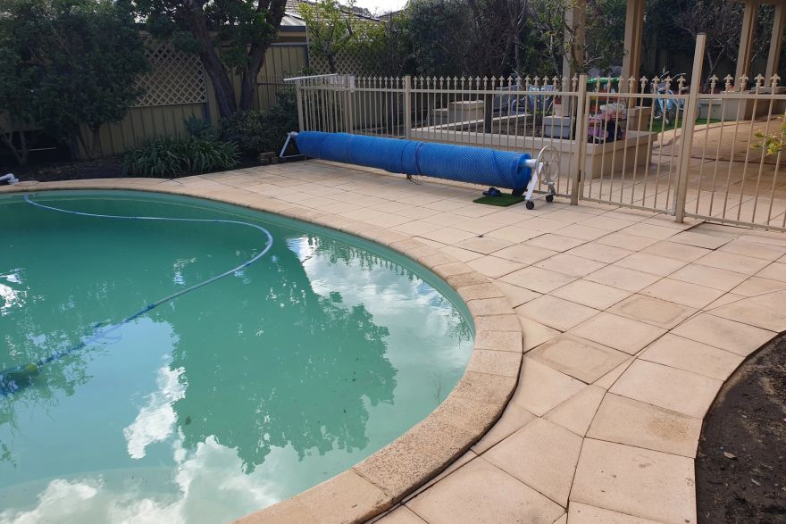 Before and after cleaning on sandstone pavers · Poolside: after