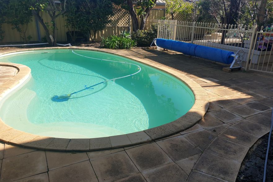 Before and after cleaning on sandstone pavers · Poolside: before