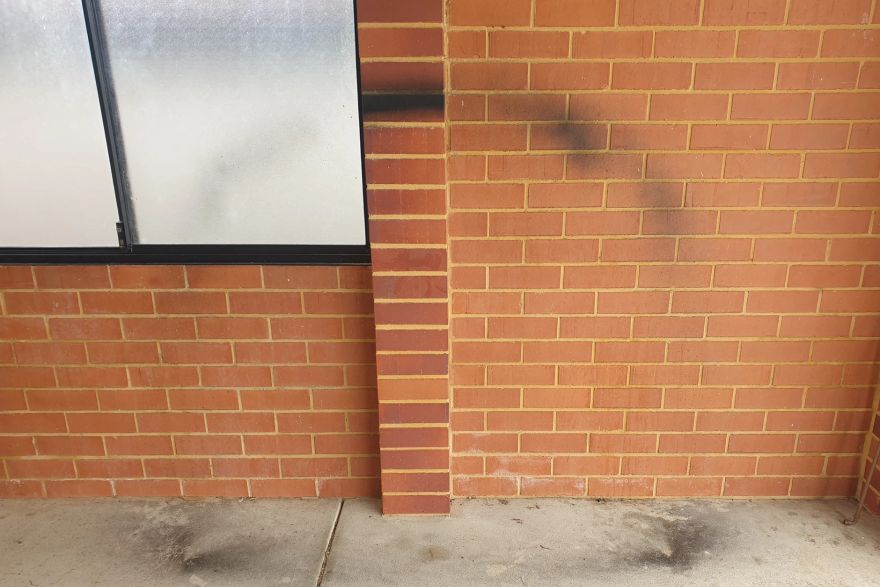 Before and after graffiti on brick pavers: before
