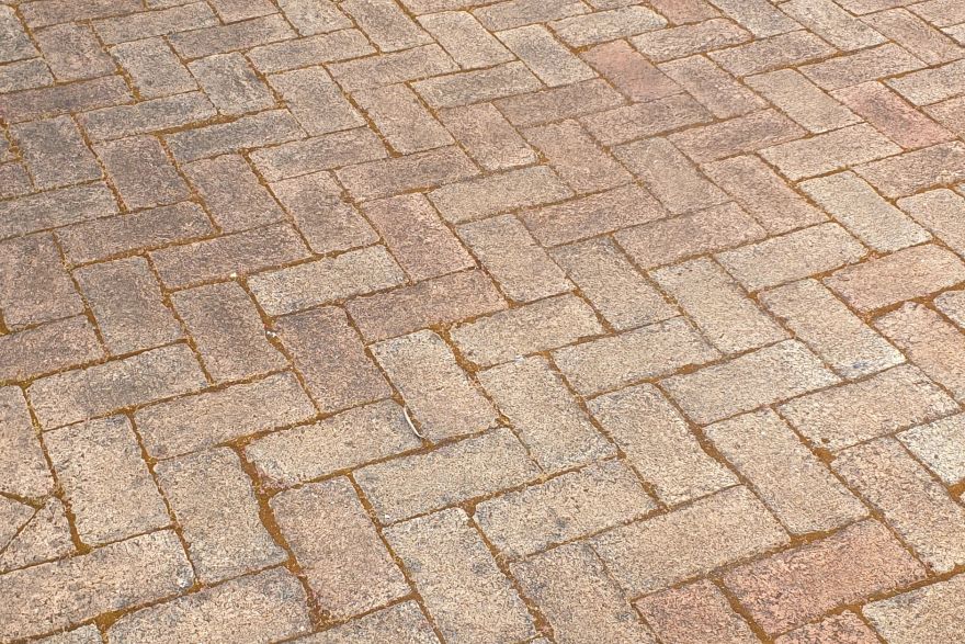 Before and after cleaning on brick pavers: before