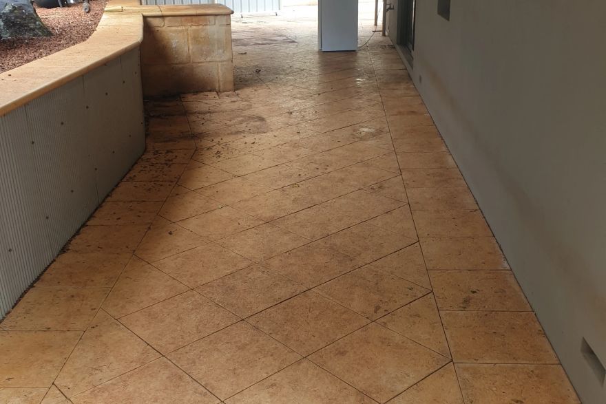Before and after cleaning on sandstone pavers: before