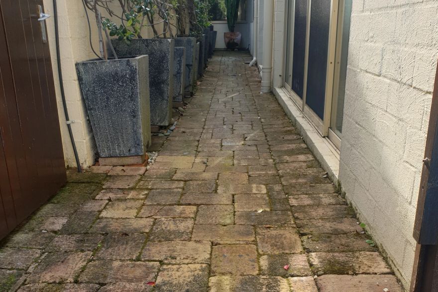 Before and after cleaning on brick pavers · Path: before