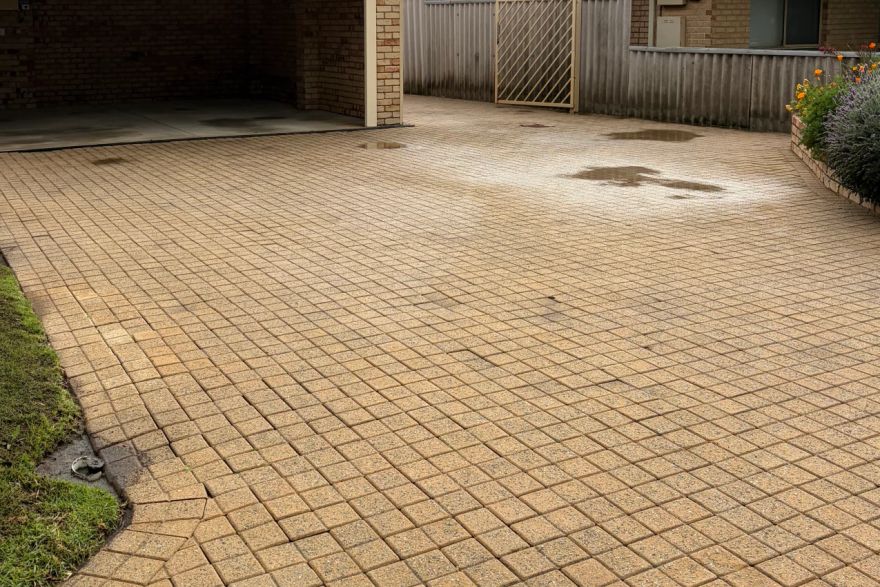 Before and after cleaning on brick pavers · Driveway: after