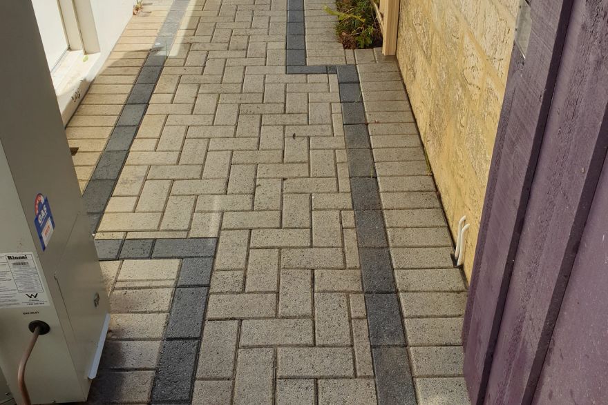 Before and after cleaning on brick pavers · Path: after