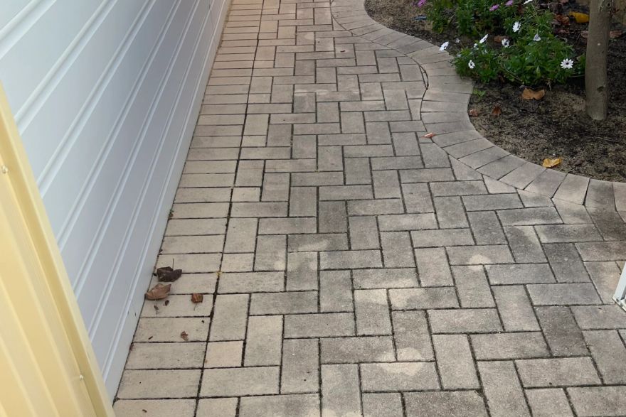 Before and after cleaning on brick pavers: before