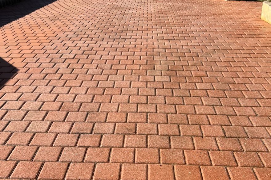 Before and after cleaning on brick pavers · Driveway: after