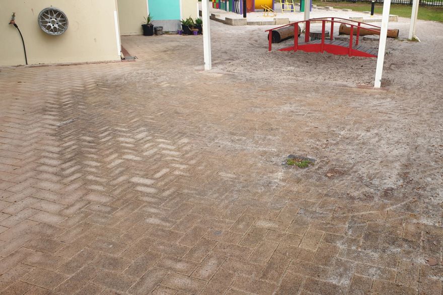 Before and after cleaning on brick pavers: before
