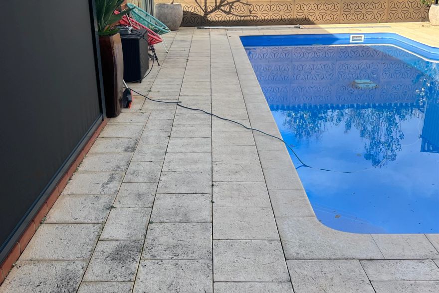 Before and after cleaning on sandstone pavers · Poolside: before
